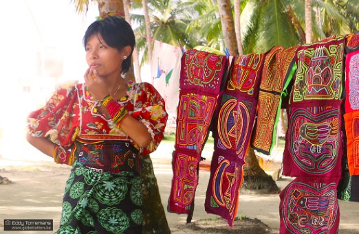 San Blas Islands A young indigenous Guna girl trying to make some business by selling some colorful handwoven clothes. San Blas Islands - November 16, 2021