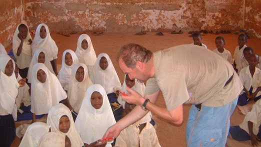 Donating pens Donating pens to the kids, unfortunately I did not had enough for all and felt very sad - Zanzibar - august 2006